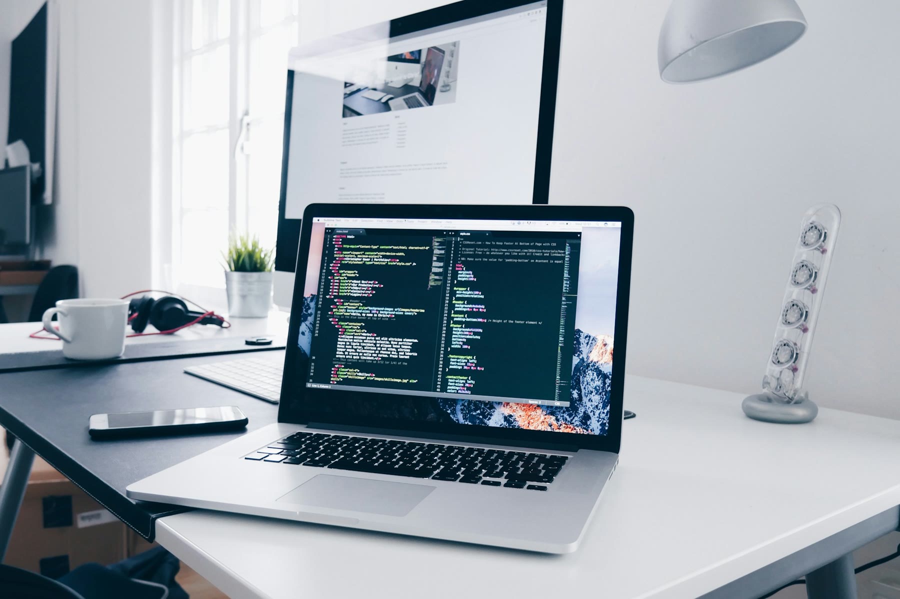 Laptop on a desk, the kind of setup a one-person shop actually uses
